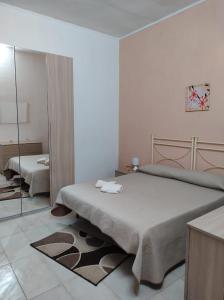 a bedroom with a large bed and a mirror at Casa Natura in Avola