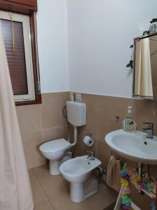a bathroom with a toilet and a sink at Casa Natura in Avola +42 photos