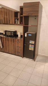 a kitchen with a refrigerator and a counter top at Zeimet Villa - Bujumbura in Mutobo