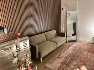 a living room with a couch and a mirror at The Amy Su in San Fernando
