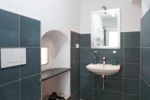 a bathroom with a sink and a mirror at -Casa Trevisone- in Salerno