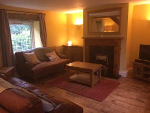 a living room with a couch and a table at High House Cottage - A traditional home from home in St Bees