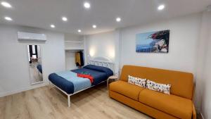 a small bedroom with a bed and a couch at Casa Nina in Amalfi