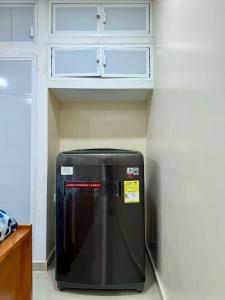 a refrigerator in a kitchen with white cabinets at casa campo in Estación El Salto