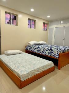 two beds sitting in a room with windows at casa campo in Estación El Salto
