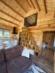 a living room with a couch and a table in a cabin at Chalet Chalus in Châlus