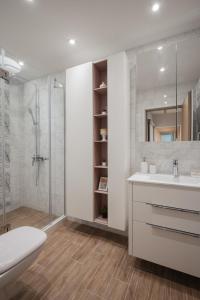 a white bathroom with a sink and a shower at Brand New Luxury Apartments with Great Views in Sofia