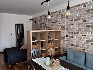 a living room with a brick wall at Студио Бяла in Byala