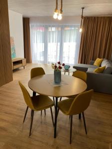 a living room with a table and chairs at Diamond Houses in Námestovo +13 photos