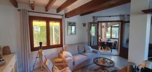 a living room with a couch and a table at Casa el Montcel, a unique chalet with roofterrace and shared pool in Denia