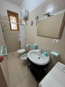 a bathroom with a sink and a toilet at Casa Vacanza Chalet in Campomarino