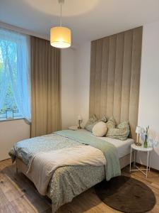 a bedroom with a large bed and a window at ZaciszeHouse in Noworąblów