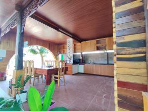 a kitchen with wooden cabinets and a table and chairs at Moc's Homestay-Phan Thiết in Ấp Tân Bình (2)