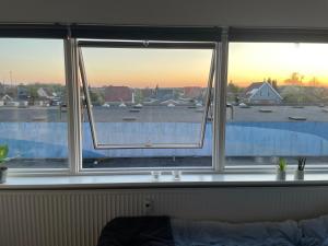 a window in a room with a view of a city at Small but cozy 1 bedroom Apartment with Living room in Hvidovre