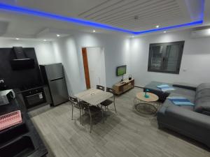 a living room with a couch and a table at Résidence Inès Djerba Appartement de Luxe in Houmt Souk