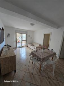 a living room with a table and a couch at Villa DaMare in Pulsano