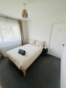 a bedroom with a bed with a blue towel on it at Base in the Black Country, 4 Beds & Large Drive in Brownhills