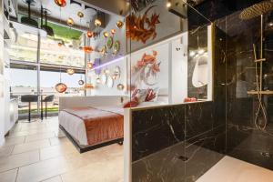 a master bedroom with a bed and a shower at Le Daïquiri Renovated Apartment with Terrace in the Naturist Village in Cap d'Agde