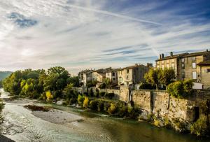a river in a town with houses and buildings at Gîte l échappée bleue Dromoise - appartement in Aouste-sur-Sye +4 photos