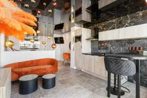 a lobby with a bar and orange chairs at Le Daïquiri Renovated Apartment with Terrace in the Naturist Village in Cap d'Agde