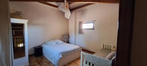 a small bedroom with a bed and a window at La Ribasse en Provence in Venelles