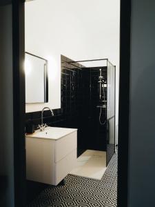 a bathroom with a white sink and a shower at Casëto Luberon in Apt