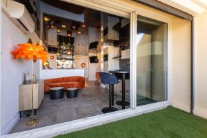 a view of a living room with a large window at Le Daïquiri Renovated Apartment with Terrace in the Naturist Village in Cap d'Agde +9 photos