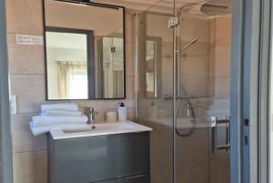a bathroom with a sink and a shower at Hôtel La Petite Bohème in Le Lavandou +111 photos