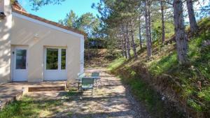 a cottage in the woods with a table and chairs at Gîte l échappée bleue Dromoise - appartement in Aouste-sur-Sye