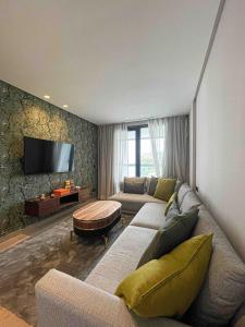 a living room with a couch and a flat screen tv at Tedy Panorama 5 094 in Tangier