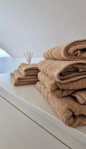 a pile of towels sitting on a shelf at Bez Pośpiechu Mazury in Suchy Róg