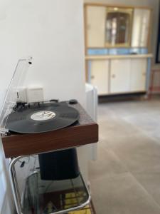 a record player sitting on top of a table at Cozy vintage BNB house in Yerville