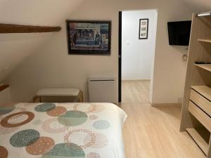 a bedroom with a bed with a flowered comforter on it at Cozy vintage BNB house in Yerville