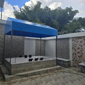 a jacuzzi tub with a blue roof at Hotel Valle del Café - Habitación con Jacuzzi 4 in Sevilla +1 photo