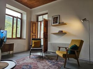 a living room with two chairs and a lamp at Ponti House Dilijan - beautiful 2 bedroom house and separate 1 bed unit, sleeps 6 in Dilijan