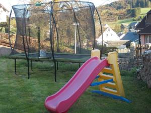a playground with a slide and a gazebo at Ferienwohnung Neubert in Eibenstock