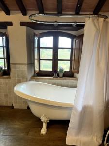 a bath tub in a bathroom with a window at Villa Bellora in Cortona +34 photos
