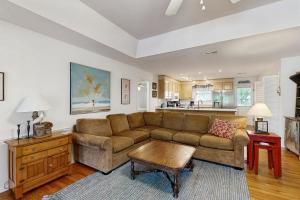 a living room with a couch and a table at Cupid's Nest in Edisto Beach