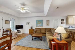 a living room with a couch and a table at Cupid's Nest in Edisto Beach