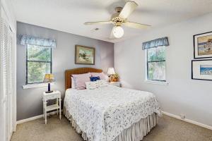 a bedroom with a bed and a ceiling fan at Cupid's Nest in Edisto Beach
