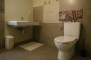a bathroom with a toilet and a sink at House Natale in Donje Selo na Šolti +26 photos