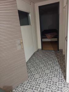 a hallway with a door and a tile floor at la p'tite maison d'olima in Épinal