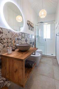 a bathroom with a sink and a mirror and a tub at La Casina in Carrara