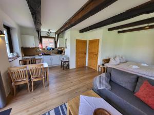 a living room with a couch and a kitchen at Altes Backhaus Bauernhof Vogel in Rohrsen +9 photos