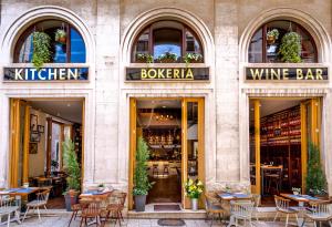 a restaurant with tables and chairs in front of a building at Abokamento Boutique Rooms in Split