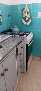 a kitchen with a stove and a counter top at Monis House in Buenos Aires