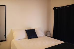 a bedroom with a bed with a black curtain at Casa Don Quijote in Concepción de Ataco +7 photos