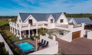 an aerial view of a house with a swimming pool at Wildehaven in St Francis Bay