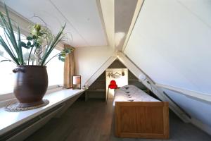 a room with a vase on a shelf in a attic at Bungalow Callantsoog in 't Zand