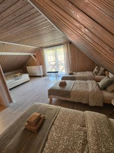 a large room with two beds in a attic at Ubytovanie Hronec in Hronec